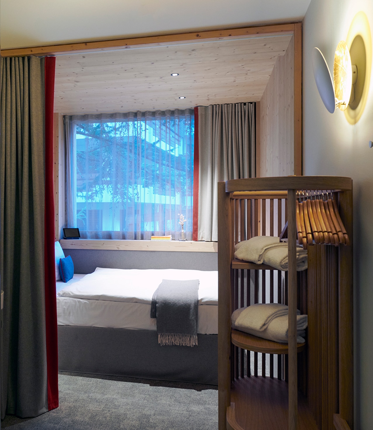 Double room at Hotel Carina Zermatt featuring a comfortable double bed and alpine wood design.