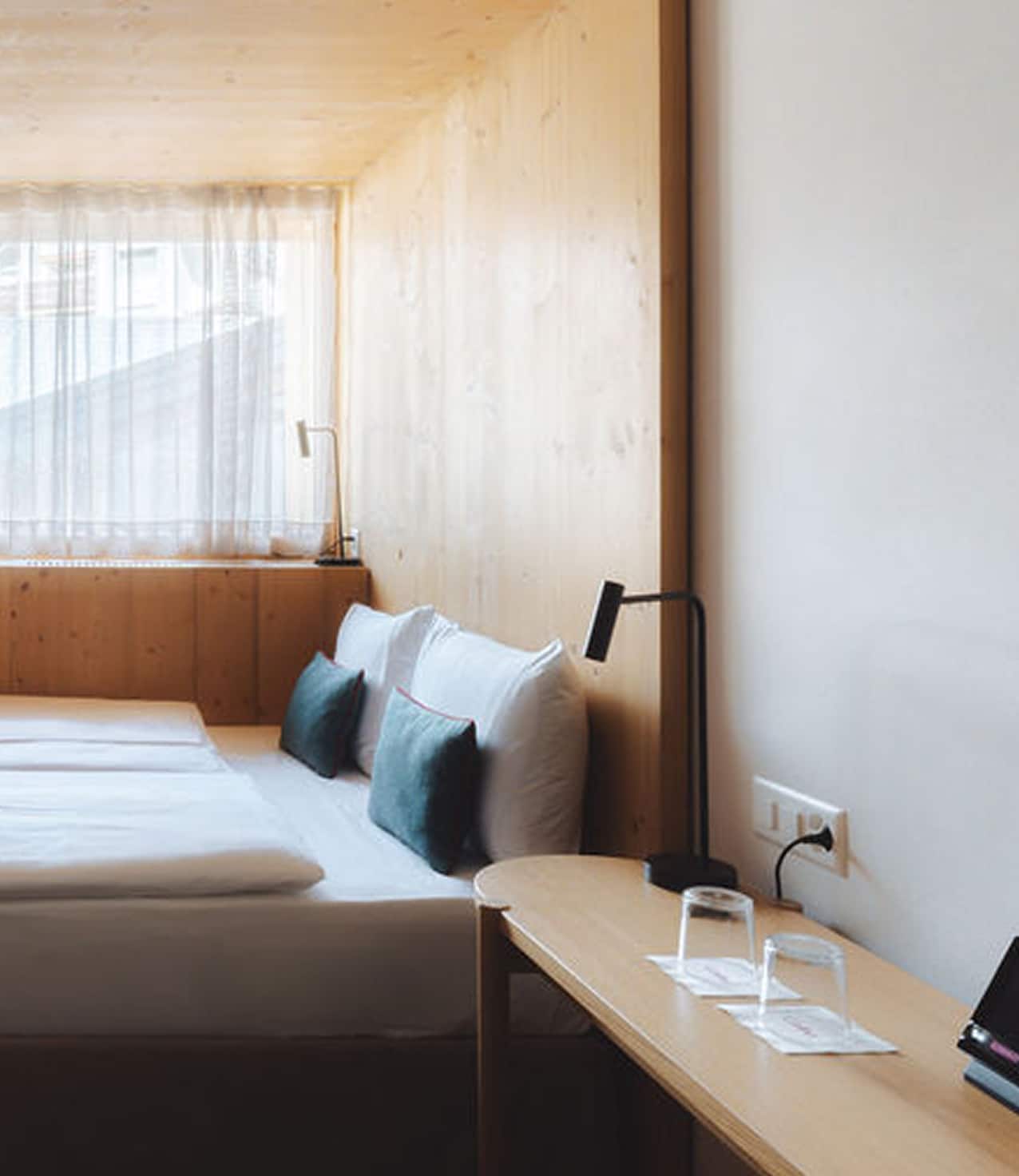 Detail shot of the double bed in the Double Cocoon room at Hotel Carina Zermatt.