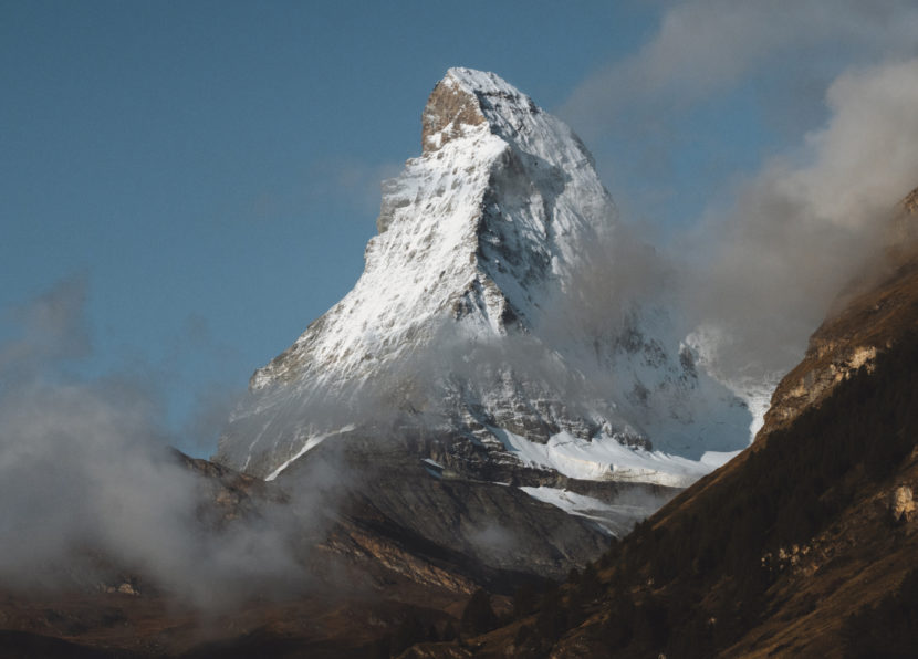 The Matterhorn rising through clouds above an alpine landscape